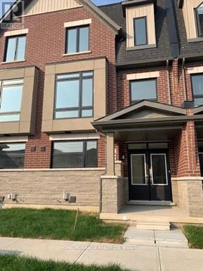 Brampton (Northwest Brampton) townhouse for rent - A brick building with a black door and windows.
