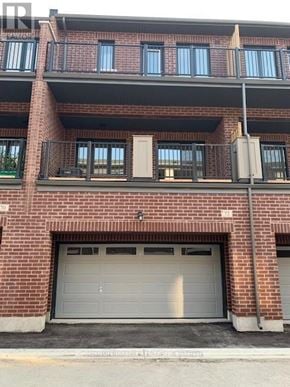 Brampton (Northwest Brampton) townhouse for rent - A red brick building with a white garage door.