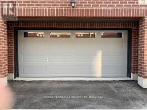 Brampton (Northwest Brampton) townhouse for rent - A garage door is closed and has a number 72 on the top left corner.