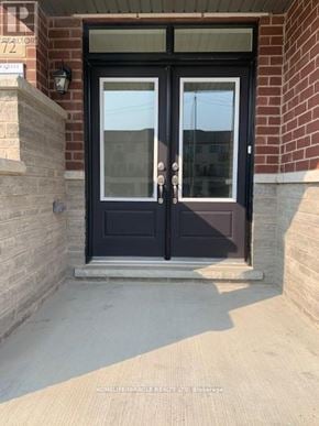 Brampton (Northwest Brampton) townhouse for rent - A black double door with a glass window is set in a brick wall.