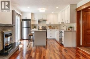 Milton apartment for rent - A modern kitchen with wood floors and white cabinets.