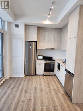 Vaughan (Vaughan Corporate Centre) condo for rent - A kitchen with wooden cabinets and stainless steel appliances.