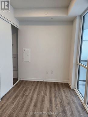 Vaughan (Vaughan Corporate Centre) condo for rent - A room with wooden flooring and a window.