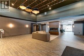 Hamilton (Waterdown) condo for rent - A spacious office lobby with a reception desk and a seating area.