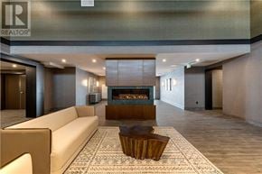 Hamilton (Waterdown) condo for rent - A living room with a fireplace and a couch.