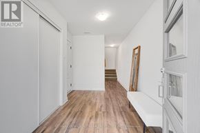 Ottawa townhouse for rent - A hallway with wood floors and white walls.