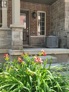 Burlington (Freeman) townhouse for rent - A house with a brown door and a window with a white frame.