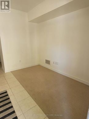 Burlington (Freeman) townhouse for rent - A room with white walls and a striped rug on the floor.