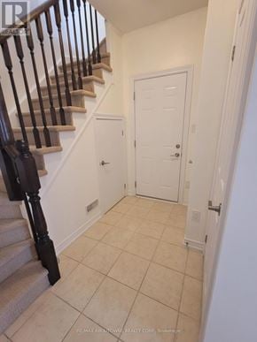 Burlington (Freeman) townhouse for rent - A hallway with a staircase and a white door.