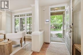 Toronto (The Beaches) apartment for rent - A white room with a table and chairs and a doorway leading to a backyard.