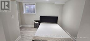 Markham (Wismer) apartment for rent - A bedroom with a bed, nightstand, and window.