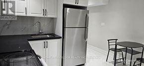 Markham (Wismer) apartment for rent - A kitchen with a refrigerator, sink, and table.