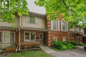 Guelph (Willow West/Sugarbush/West Acres) townhouse for rent - A house with a brick facade and a green lawn in front.