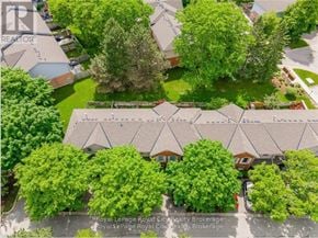 Guelph (Willow West/Sugarbush/West Acres) townhouse for rent - A bird's eye view of a residential area with houses and trees.