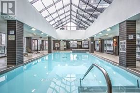 Toronto (Niagara) condo for rent - A swimming pool inside a building with a glass ceiling.