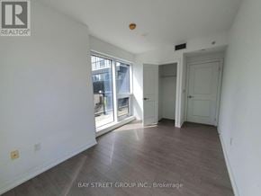 Toronto (Moss Park) condo for rent - A room with a sliding glass door leading to a balcony.