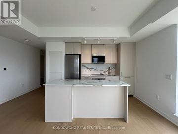 Toronto (Regent Park) condo for rent - A kitchen with white cabinets and a white island with a sink.