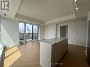 Toronto (Regent Park) condo for rent - A spacious, well-lit room with a view of the city through large windows.
