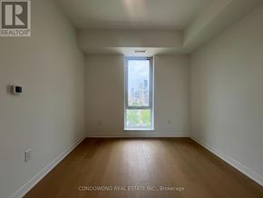 Toronto (Regent Park) condo for rent - Empty room with a window and wooden flooring.