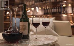 Toronto (Annex) condo for rent - A bottle of wine and two glasses of wine on a table.