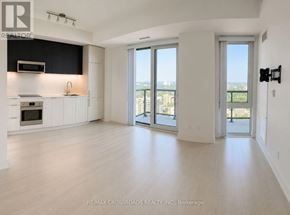 Toronto (Church-Yonge Corridor) condo for rent - A spacious, empty room with a view of the city through large windows.