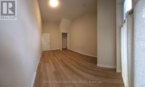 Toronto (University) apartment for rent - A room with wooden flooring and white walls.