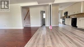 Richmond Hill (Crosby) apartment for rent - A spacious kitchen with white cabinets and a wooden floor.