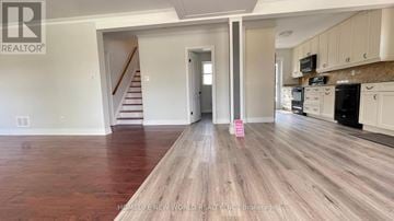 Richmond Hill (Crosby) apartment for rent - A spacious kitchen with white cabinets and a wooden floor.