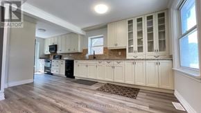 Richmond Hill (Crosby) apartment for rent - A kitchen with white cabinets and a wooden floor.
