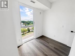 Brantford condo for rent - A room with a sliding glass door leading to a street.