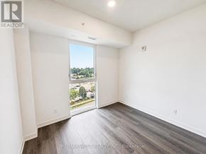 Brantford condo for rent - A room with a view of a parking lot through a glass door.