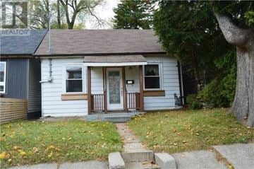 Toronto (Greenwood-Coxwell) apartment for rent - A small house with a porch and a tree in front.