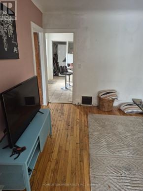Toronto (Greenwood-Coxwell) apartment for rent - A room with a television and a rug on the floor.