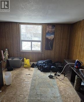 Toronto (Greenwood-Coxwell) apartment for rent - A room with wooden walls and a window with a painting on it.