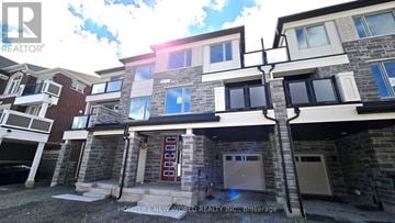 Markham (Victoria Square) townhouse for rent - A building with a blue door and windows is shown in the image.