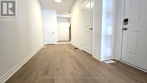 Markham (Victoria Square) townhouse for rent - A hallway with white walls and wood flooring.