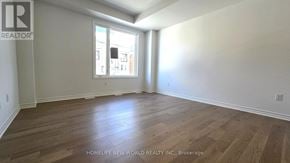 Markham (Victoria Square) townhouse for rent - A room with wooden flooring and a window letting in natural light.