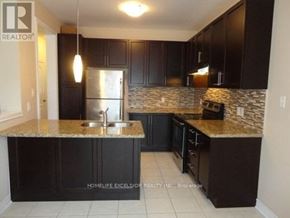Markham (Greensborough) apartment for rent - A kitchen with a granite countertop and a refrigerator.