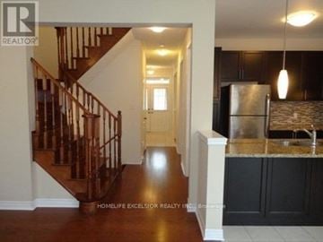 Markham (Greensborough) apartment for rent - A well-lit kitchen with a refrigerator and a staircase.