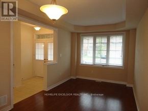 Markham (Greensborough) apartment for rent - A room with a brown floor and a window with blinds.