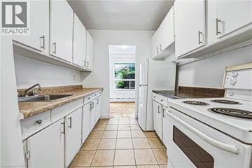 Hamilton apartment for rent - A white kitchen with a tile floor and white appliances.