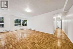 Hamilton apartment for rent - A room with wooden flooring and white walls.
