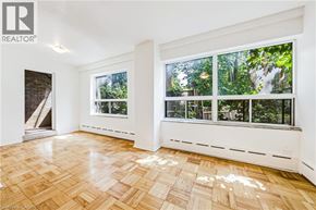 Hamilton apartment for rent - A room with a window overlooking a forest.
