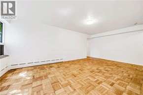 Hamilton apartment for rent - A room with wooden flooring and white walls.