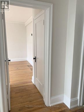 Stratford multi-family for rent - A white door is open to a hallway.