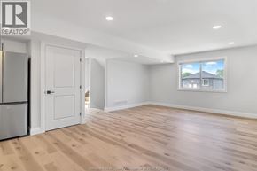 Windsor apartment for rent - A realtor's office with a fridge and a window.