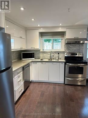 Newmarket (Gorham-College Manor) apartment for rent - A modern kitchen with white cabinets and stainless steel appliances.
