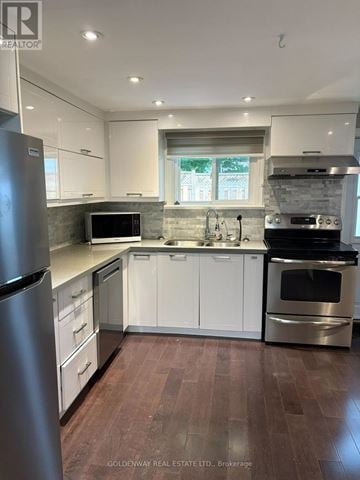 Newmarket (Gorham-College Manor) apartment for rent - A modern kitchen with white cabinets and stainless steel appliances.