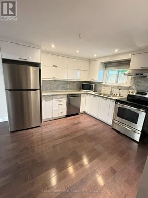 Newmarket (Gorham-College Manor) apartment for rent - A kitchen with wooden floors and white cabinets.