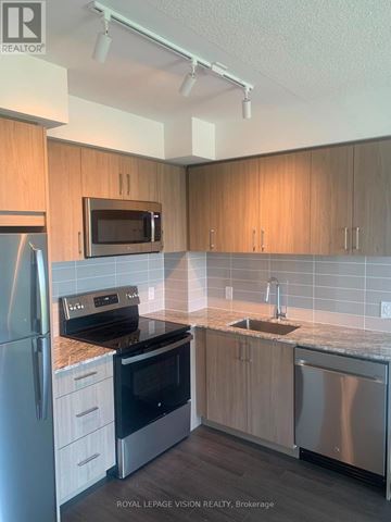 Toronto (Humber Heights) condo for rent - A kitchen with wooden cabinets and stainless steel appliances.